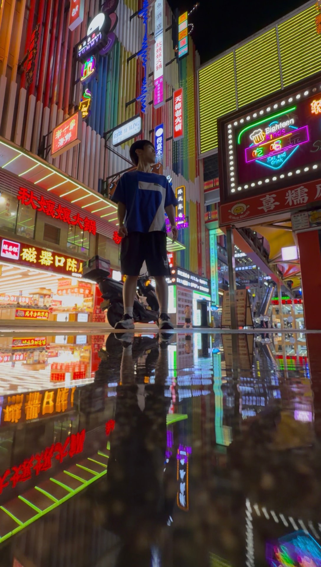 Reflection portrait on a neon hotpot street