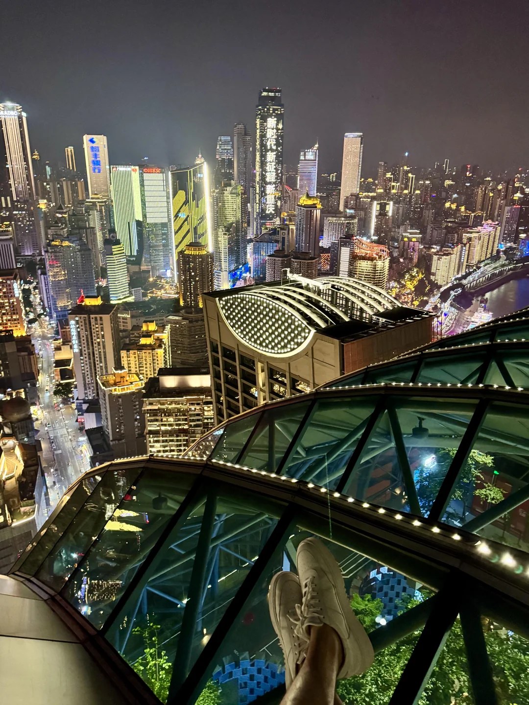 Feet over the glass deck above Jiefangbei